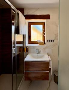 a bathroom with a sink and a glass shower at Libelle Andalusian Hideaway C in Granada