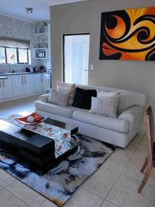 a living room with a couch and a table at ChoosersExpressHotel in Centurion