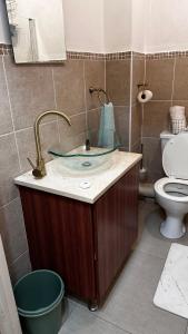 a bathroom with a sink and a toilet at Zenko Suave- 12 Madison West in Johannesburg