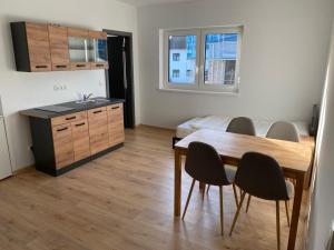 a kitchen and dining room with a table and chairs at Zimmer mit Bad und Küche in Rötgesbüttel