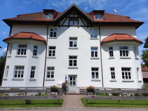 a large white building with a red roof at Top! Wohnung direkt am Fuß der Berge im Oberallgäu in Immenstadt im Allgäu +26 photos