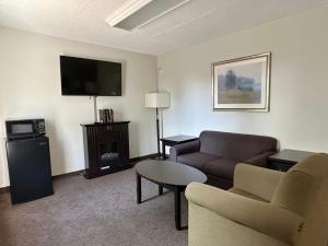 a living room with a couch and a tv at Travelodge by Wyndham Welland in Welland