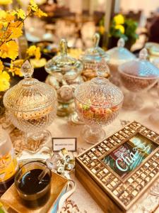 a table topped with glass bowls and a plate of food at HOTEL CAMPO GRANDE in Campo Grande +32 photos
