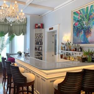 a bar with chairs and a counter in a room at Rosedon in Hamilton