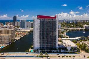 a tall building with a red roof on top of it at Miami Studio 2 Full Beds in Hallandale Beach