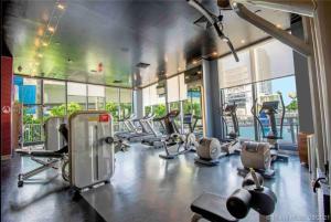 a gym with several treadmills and elliptical machines at Miami Studio 2 Full Beds in Hallandale Beach