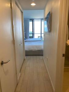 a hallway with a room with a bed and a bedroom at Miami Studio 2 Full Beds in Hallandale Beach