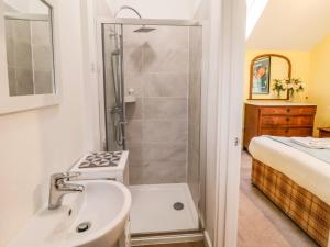 a bathroom with a shower and a sink at The Stable in Lyme Regis