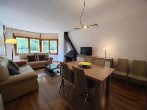 a living room with a table and a couch at Allotjaments Bruc in Camprodon