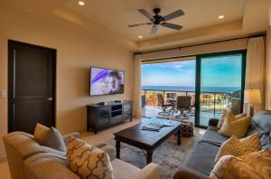 a living room with a couch and a table at Memory Maker Copala Corner Unit Ocean View in Cabo San Lucas