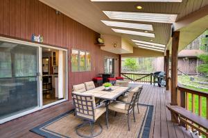 a patio with a table and chairs on a deck at New York Retreat - Furnished Deck and Mountain Views in Lanesville
