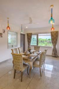 a dining room with a table and chairs at SaffronStays Ivory Mansion in Pen