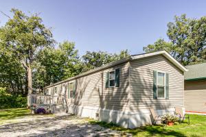 a small house with two chairs in front of it at Oak Harbor Walleye Camp in Baudette