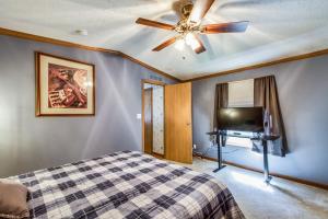 a bedroom with a bed and a ceiling fan at Oak Harbor Walleye Camp in Baudette