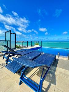 a group of blue picnic tables sitting on top of a building at Vistamar Hotel in Maceió