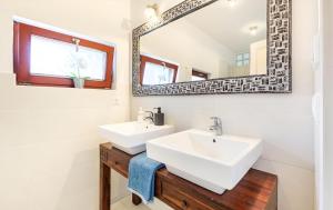 a bathroom with two sinks and a mirror at Maharaja Mountain Palace with Free Privat Parking and Garden in Budapest