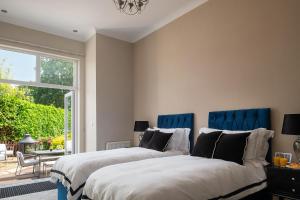 two beds in a room with a window at Number 3 in Trefriw