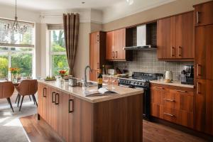 a kitchen with wooden cabinets and a counter top at Number 3 in Trefriw
