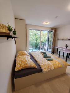 una camera da letto con un letto con cuscini sopra di A Star Apartment Brno with Terrace a Brno