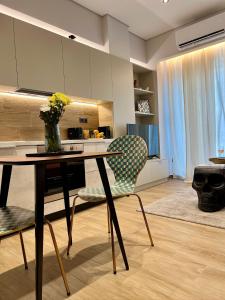 a kitchen with a table with a vase of flowers at Jack, 2 people, renovated stylish apartment in Athens