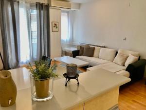 a living room with a couch and a table at First Choice Apartment in Skopje