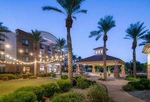 a hotel with palm trees and a gazebo at SpringHill Suites Phoenix Glendale Sports & Entertainment District in Glendale