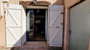 an open door of a building with a white gate at Studio Au Pied De La Sainte Victoire in Puyloubier