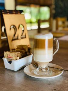 a cup of coffee sitting on top of a table at THE GALAXY FOREST LODGE in Manguzi