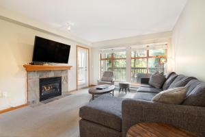 a living room with a couch and a fireplace at Whistler Vacation Club at Twin Peaks in Whistler