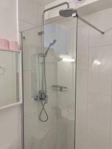 a shower with a glass door in a bathroom at Studio number 7 in Pantin