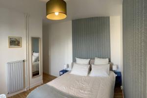 a bedroom with a large bed with white pillows at Studio number 7 in Pantin
