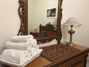 a pile of towels sitting on a table in front of a mirror at Selinunte Street House in Castelvetrano Selinunte +17 photos