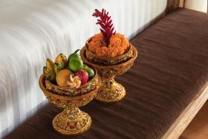 two bowls of fruit sitting on a table at The Kanjeng resort Ubud in Ubud