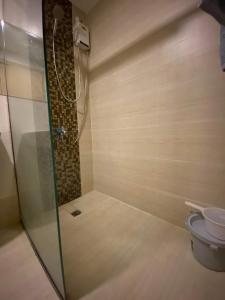 a bathroom with a shower and a toilet at Hyde Tower in Cebu City