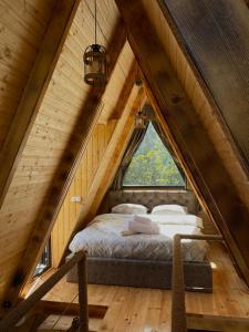 ein Bett im Dachgeschoss eines Baumhauses in der Unterkunft HillSide Cottage in K'eda