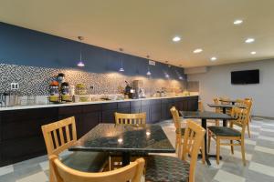 a restaurant with tables and chairs and a counter at Quality Inn - Needles in Needles