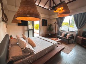 a living room with a bed and a couch at MAPUWI Villa & Suite in Palomino +109 photos