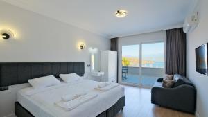 a bedroom with a bed with a view of the ocean at Miralya Suites in Fethiye