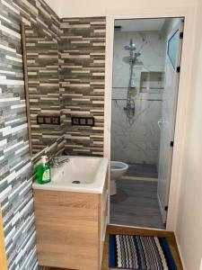 a bathroom with a sink and a shower and a toilet at Padova Surf House in Imsouane +54 photos