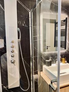 a bathroom with a shower and a sink at Alice, 2-4 people, renovated stylish apartment in Athens