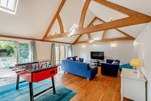 a living room with a foosball table in the middle at Court Lodge Oast in Heathfield