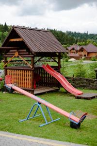 a playground with a slide and a gazebo at Смарагдовий пагорб in Plav'ya