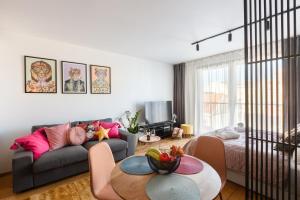 a living room with a couch and a table at Urban Chic Residences in Prague