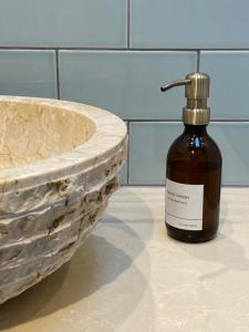 a bottle of soap on a counter next to a sink at Stylish 3 bedroom apartment in historic city centre building in Sheffield