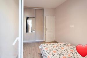 a bedroom with a bed with a heart on it at Logement en plein coeur avec terrasse in Nice