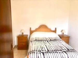 a bedroom with a bed with two dressers and two lamps at Casa Vista Mar -2 bedrooms,fantastic Seaview in Estreito da Calheta