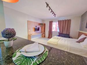 a hotel room with a bed and a table at Rize Studios in Maceió