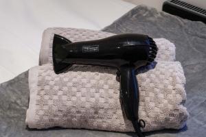 a hair dryer sitting on top of a piece of cloth at Boutique Apartment - City Centre - Free Parking, Fast Wifi and Smart TV by Yoko Property in Rugby