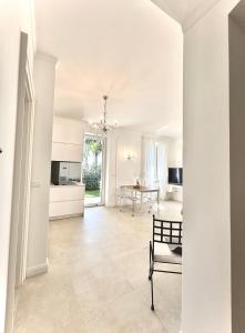 a white living room with a table and a chair at VILLA GIANNI - lux. apt. ROMA -5* in Lovran +34 photos