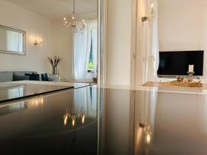 a living room with a couch and a television in a room at VILLA GIANNI - lux. apt. ROMA -5* in Lovran